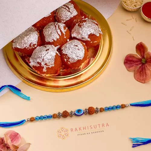 Charming Evil Eye Rakhi N Ghee Laddu Combo
